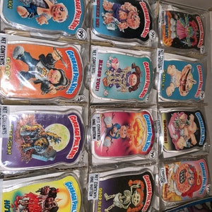 Full set of 12 mint sealed in packages Topps Garbage Pail Kids Buttons