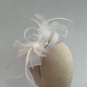 New white headband and clip mesh bow shape fascinator with added feathers