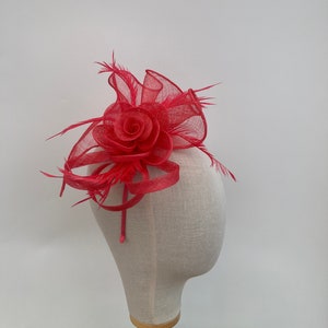 Coral sinamay twisted base with flower headband and clip fascinator