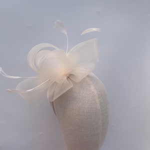 New cream wide loop mesh fascinator with added feathers on changeable headband or clip