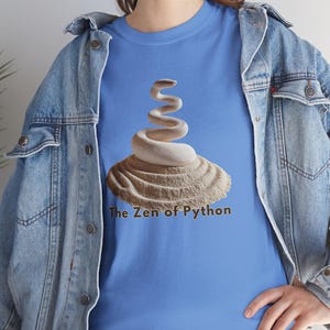 Carolina blue t-shirt with a high-contrast glowing Zen Python design. Perfect gift for software engineers, tech leads, and data science professionals. Edgy but clean programming style.