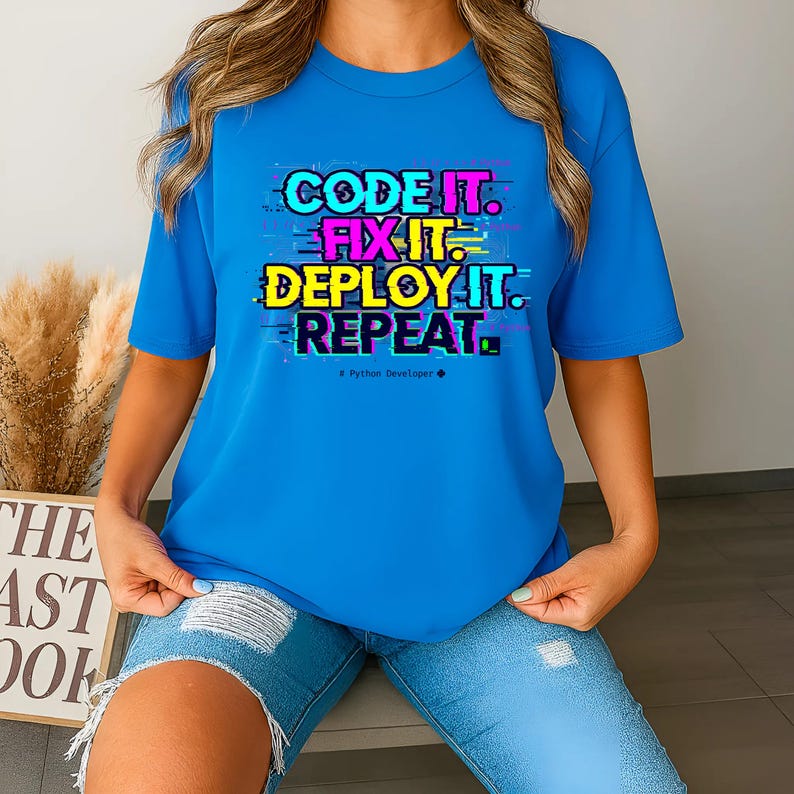 Antique Sapphire shirt with a bright professional glitch print. A funny and stylish gift for software developers and tech leads. Features a bold repeat cycle coding mantra.