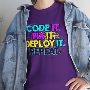 Purple shirt with a bright professional glitch print. A funny and stylish gift for software developers and tech leads. Features a bold repeat cycle coding mantra.