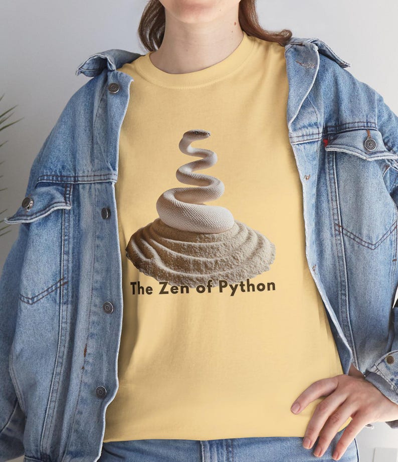 Yellow haze t-shirt featuring a detailed white python snake in a serene Zen sand garden. "The Zen of Python" motto for developers. High-end, sophisticated STEM graphic.
