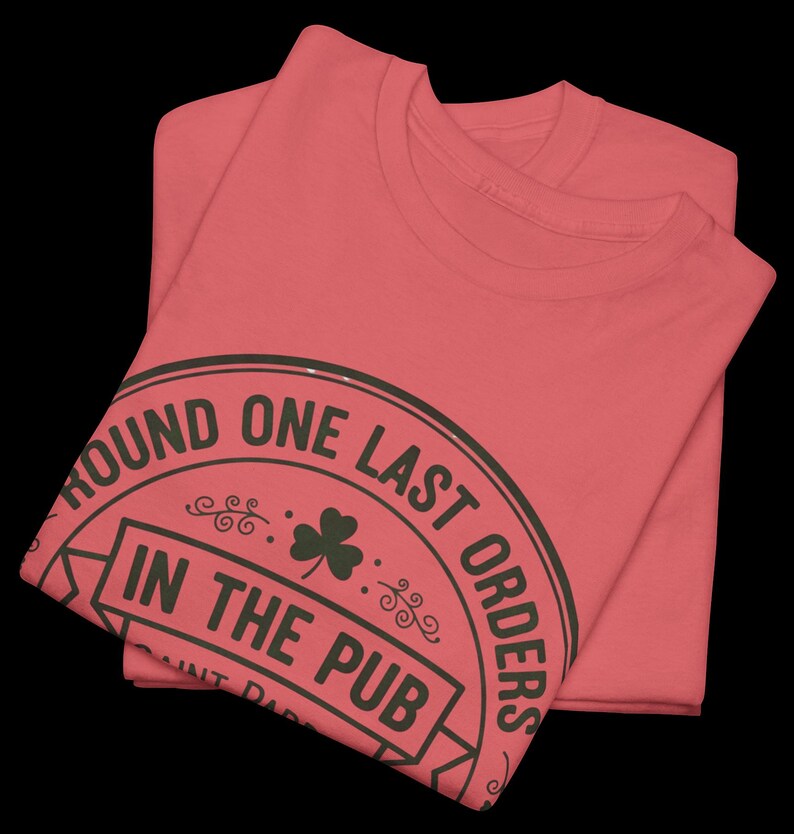 Coral Silk unisex t-shirt featuring the "Good Craic Ahead" pub seal design in dark green. A fun, playful twist on traditional St. Patrick's Day gear, perfect for women or men who want a softer color palette while keeping the Irish drinking humor.