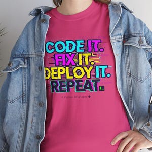 heliconia pink shirt with a bright professional glitch print. A funny and stylish gift for software developers and tech leads. Features a bold repeat cycle coding mantra.
