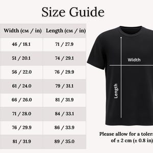 May include: A black t-shirt with a size guide. The guide shows measurements for width and length in both centimeters and inches, ranging from size S to 5XL. The text "Please allow for a tolerance of &plusmn; 2 cm (&plusmn; 0.8 in)" is also included.