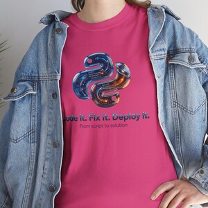 Heliconia pink t-shirt with a high-contrast 3D liquid python graphic. The glowing internal code highlights the "Code it. Fix it. Deploy it." motto. Energetic and eye-catching gift for tech-savvy graduates and software developers.