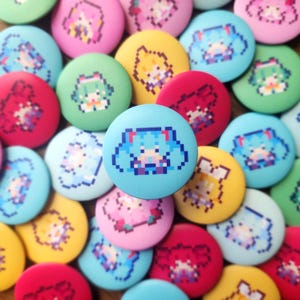 May include: A selection of vibrant, circular badges showcasing pixelated anime character designs. The badges are in a variety of colours, such as blue, green, yellow, pink, and red. The central badge is light blue with a pixelated anime character.