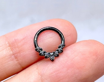 May include: Black circular body jewellery with a row of small black gemstones in a V-shape design.