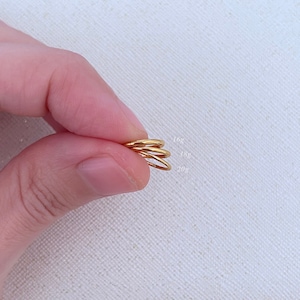 May include: Three gold hoop earrings of different sizes, labeled 16g, 18g, and 20g.