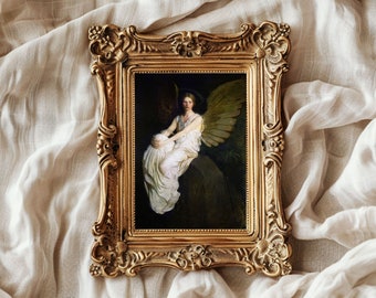 May include: A framed painting of an angel with wings, sitting on a rock. The angel is wearing a white gown and has long, flowing hair. The painting is set against a dark background.