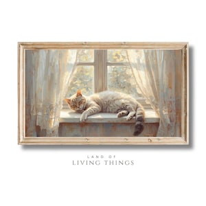 Puede incluir: Pintura enmarcada de un gato atigrado descansando en un alféizar. El gato es de color marrón claro con rayas más oscuras. Cortinas suaves y transparentes enmarcan la ventana. El texto "LAND OF LIVING THINGS" está en la parte inferior.