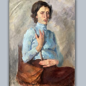 May include: A painting of a woman wearing a light blue turtleneck sweater and a brown bag. She is sitting in a chair with her hands in her lap.