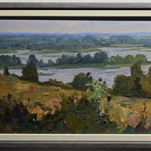 May include: Oil painting of a landscape with a river and trees. The artwork features a muted color palette of greens, browns, and blues. The painting is framed in a gray wooden frame with a white inner border.