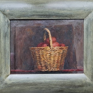 May include: A painting of a wicker basket filled with red apples, set against a dark background. The basket has a woven handle and is sitting on a red surface.