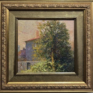 May include: An oil painting in a gold ornate frame depicts a landscape scene. A building with a red roof and a chimney is partially visible behind a large tree. The painting has a textured appearance with visible brushstrokes.
