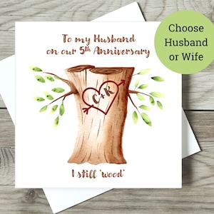 May include: A watercolor illustration of a tree stump with a heart carved into it. The heart has the initials "C+R" inside and an arrow through it. The text "To my Husband on our 5th Anniversary I still 'wood'" is written below the image. The text "Choose Husband or Wife" is written in a circle above the image.