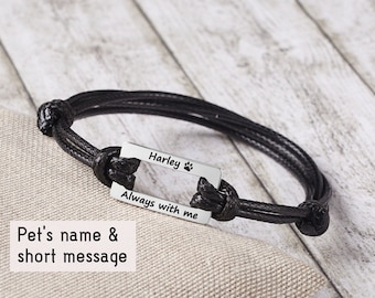 May include: Black braided bracelet with a silver rectangular charm engraved with the name "Harley" and the text "Always with me".