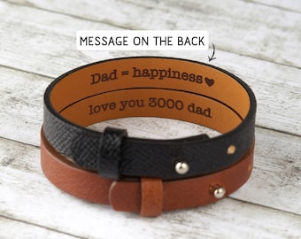 May include: A black and brown leather bracelet with a message engraved on the back: "Dad = happiness ♥ love you 3000 dad".