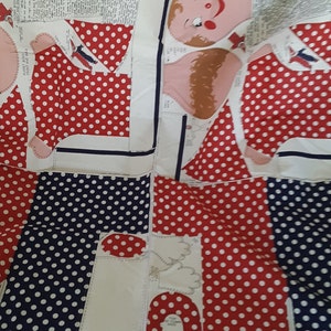 May include: A vintage sewing pattern for a clown puppet. The pattern pieces are printed on white fabric with red and blue polka dots. The pattern includes instructions for making the puppet's body, head, and arms. The text on the pattern reads "CLOWN BODY FRONT AND BACK PUPPET BODY FRONT AND BACK LINES HER NOTCH-ONE FULL YARD REQUIRED FOR SET"