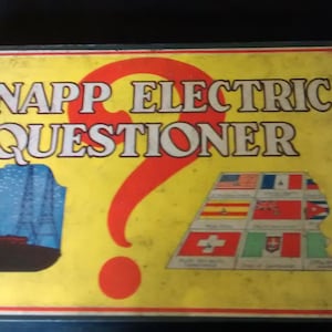 May include: A vintage game box for the Knapp Electric Questioner game. The box is yellow with red, blue, and white accents. The game features a question mark and a ship with a blue sail.