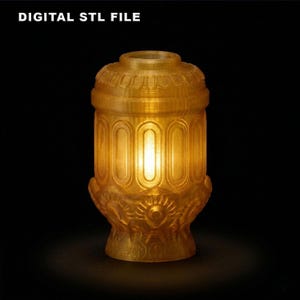 May include: A golden, ornate lamp with a cylindrical body and decorative base. The lamp features vertical oval cutouts and a detailed top. The text "DIGITAL STL FILE" is at the top. The lamp is illuminated from within, creating a warm glow.