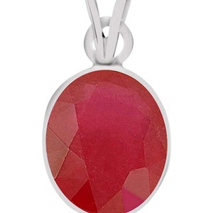 May include: A silver pendant with a red oval gemstone. The gemstone is faceted and has a shiny finish.