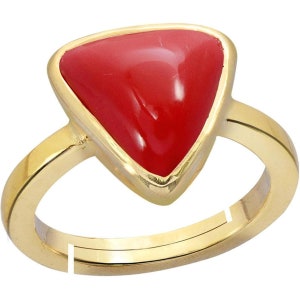May include: A gold ring with a triangular red coral gemstone.