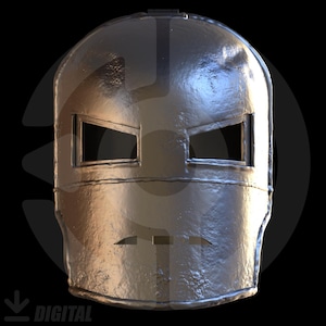 Puede incluir: Un casco plateado metálico con aberturas rectangulares para los ojos y una pequeña abertura para la boca. El casco tiene una apariencia ligeramente desgastada, lo que sugiere una estética vintage o de batalla. El diseño recuerda a una máscara de superhéroe.