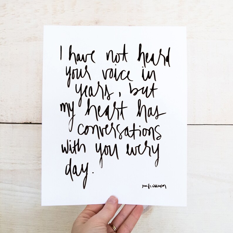 May include: Black and white typography print with the quote "I have not heard your voice in years, but my heart has conversations with you every day." The quote is attributed to "Jounifi Williagion".