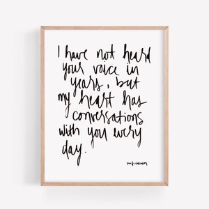 May include: Black and white typography print with the text "I have not heard your voice in years, but my heart has conversations with you every day." The print is signed "Jamie Wilkinson".