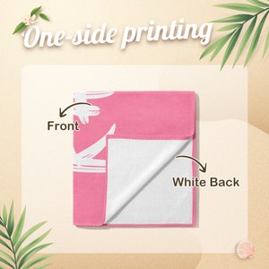 May include: A pink beach towel with a white design on the front and a white back. The text "One-side printing" is displayed at the top. The front of the towel is pink with a white design. The back of the towel is white.