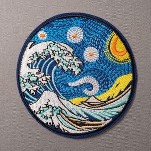 May include: A circular embroidered patch featuring a stylized design of a large white crashing wave against a deep blue background. The scene includes a bright yellow sun, white circular stars with orange centers, and a small boat on the water.