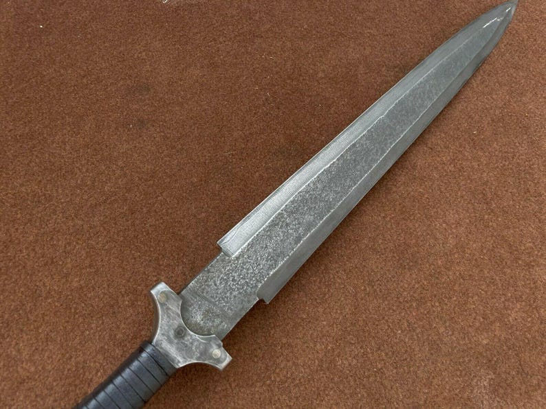 May include: A silver dagger with a textured blade and a black handle.