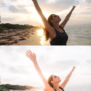 K&ouml;nnte beinhalten: Eine Frau mit erhobenen Armen steht an einem Strand mit dem Meer im Hintergrund. Der Himmel ist hellblau mit wei&szlig;en Wolken. Die Frau tr&auml;gt ein schwarzes Tanktop und eine Sonnenbrille.