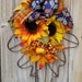 Susan Stoughton reviewed Fall Autumn Oak leaf Front Door Decor, Yellow/Orange Sunflowers, berries and leaves, Thanksgiving day Wreath by Space Coast Crafts