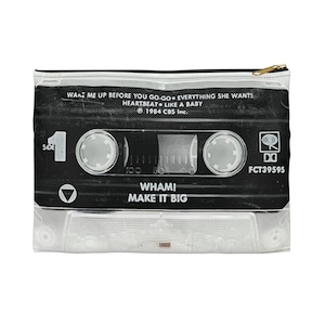 May include: A clear, rectangular zippered pouch featuring a black cassette tape design. The tape includes song titles and the text "WHAM! MAKE IT BIG." The zipper is gold-colored.