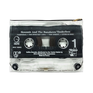May include: A clear zippered pouch featuring a black cassette tape design. The tape displays the album title "Tinderbox" by Siouxsie And The Banshees, with song titles and the Geffen Records logo. The pouch has a gold-colored zipper.