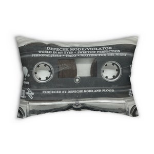 May include: Rectangular pillow featuring a black cassette tape design. The tape has the text "DEPECHE MODE/VIOLATOR" and song titles like "WORLD IN MY EYES" and "PERSONAL JESUS." The pillow is a soft, decorative item.