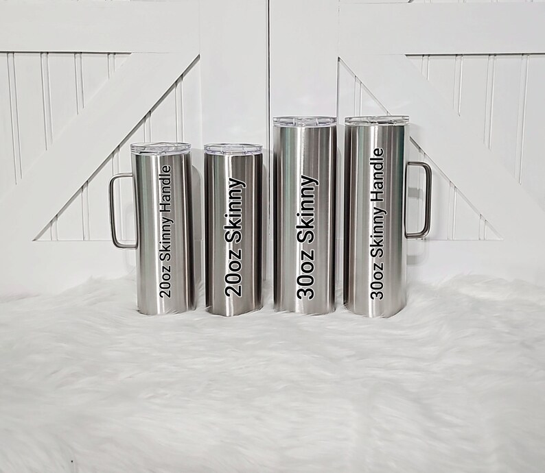 May include: Four stainless steel tumblers with handles. The tumblers are labeled with their size and type: 20oz Skinny Handle, 20oz Skinny, 30oz Skinny, and 30oz Skinny Handle.