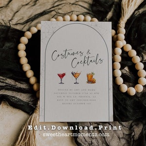 May include: A rectangular invitation card with the text "Costumes & Cocktails" in elegant script. The card features watercolor illustrations of three cocktails. Additional text includes event details and a website address.