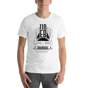 May include: White t-shirt with a black and white illustration of a Bugatti EB110 supercar with the doors open. The text "Cars About Uniqueness" and "ROAD&ART" are printed below the car.