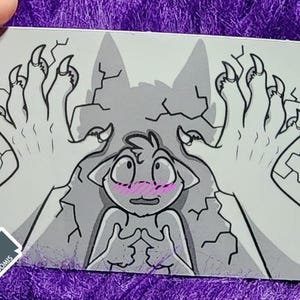 May include: A rectangular sticker with a cartoon illustration. The image features a light grey background with a cracked texture. Two large clawed hands are reaching towards a small cartoon character with a blush. The sticker has rounded corners.