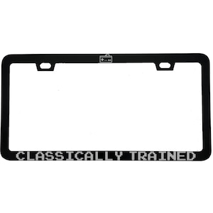 May include: A white ceramic mug with a black handle and the text "But First, Coffee" in a bold, black font. The mug is set against a neutral background, highlighting its simple design.