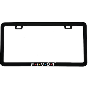 May include: Black license plate frame with the word "PIVOT" in white letters, with colored dots between the letters. The frame has a rectangular shape with rounded corners and mounting holes.
