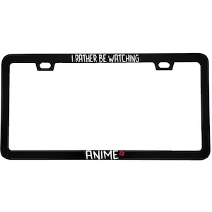 May include: Black license plate frame with white text that reads "I RATHER BE WATCHING" at the top and "ANIME" at the bottom. The word "ANIME" has a red star graphic next to it.