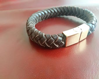 May include: A brown leather bracelet with a braided design and a gold metal clasp.