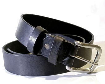May include: A black leather belt with a silver-colored buckle. The belt is rolled up, showing the texture of the leather and the details of the buckle. The belt is a classic accessory.