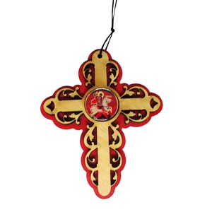 May include: A wooden cross with a red and gold design. The cross has a round, clear glass center with a picture of a saint on horseback.